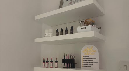 Organized beauty product shelves at GLOW By Mads, Abbots Langley, England, GB showcasing elegant simplicity.