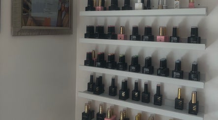 Nail polish display at 𝐆𝐋𝐎𝐖 By Mads in Abbots Langley, England, showcases vibrant colors and brands.