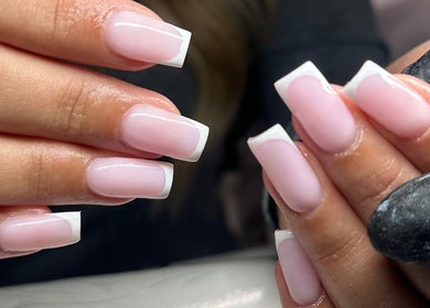 Elegant French manicure at GLOW By Mads, Abbots Langley, England, GB. Well-groomed nails with glossy finish.