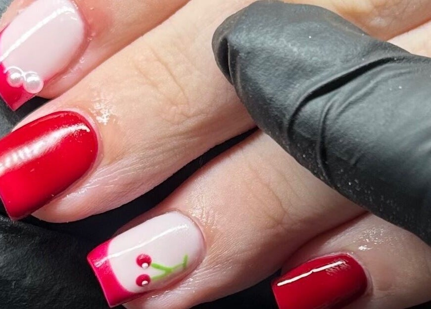 Cherry-themed nail art at Glow by Mads, Abbots Langley, England, GB. Elegant red polish with delicate designs.