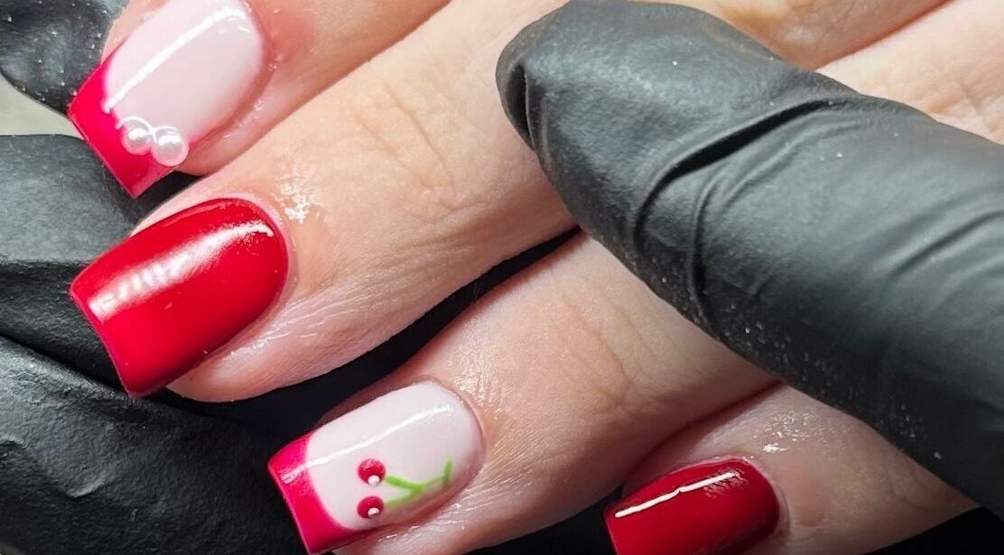 Cherry-themed nail art at Glow by Mads, Abbots Langley, England, GB. Elegant red polish with delicate designs.