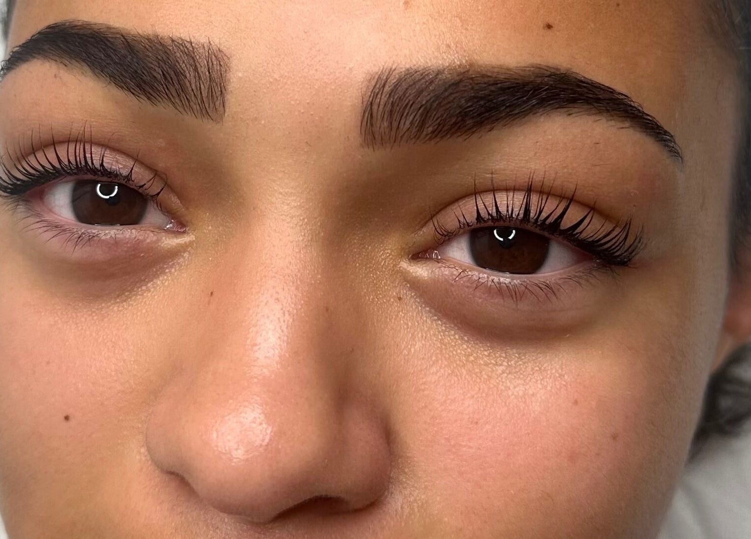 Close-up of perfectly groomed eyebrows and curled lashes at Glow by Mads, Abbots Langley, England, GB.