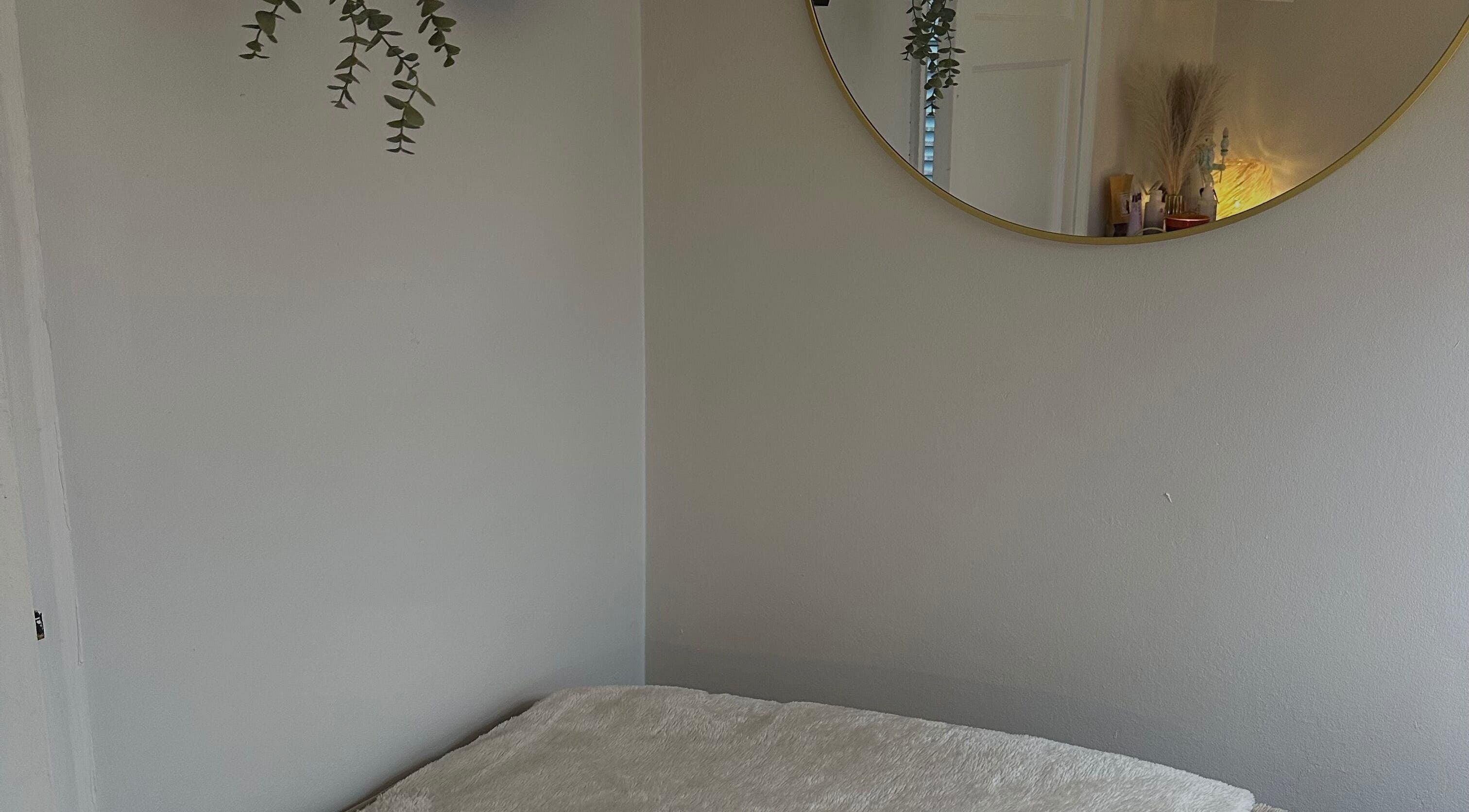 Relaxing treatment room with mirror at Glow by Mads Clinic, Abbots Langley, England, GB.