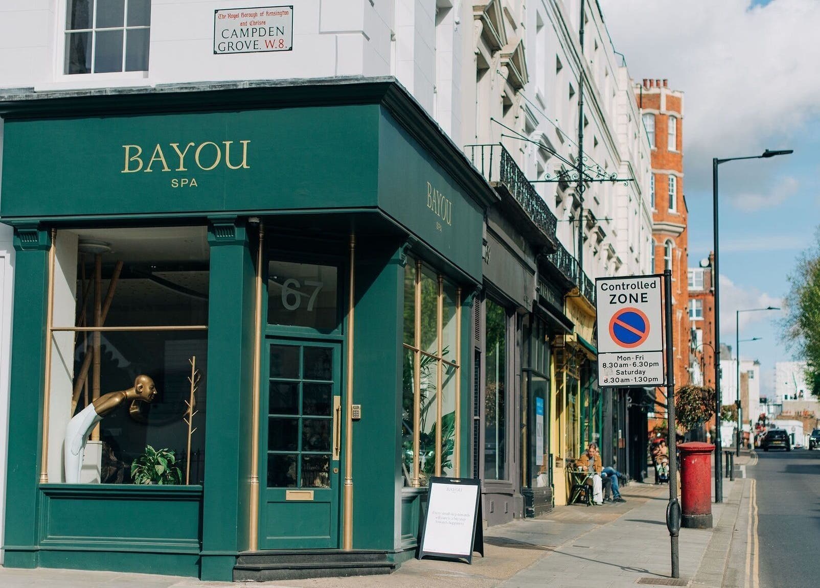 Exterior view of Bayou Spa on a sunny street in London, England, GB with elegant green facade.