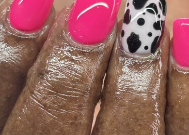 Vibrant nail art at Bahama Beauty Nail Bar in Nassau, New Providence, BS with pink and black design.