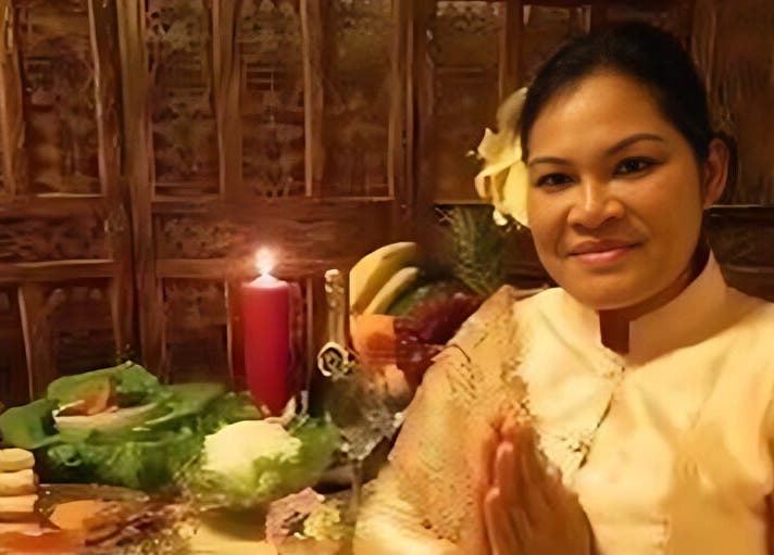 A warm welcome at Moradok Siam in Romsey, featuring a smiling hostess with a candlelit display, Romsey, England, GB.