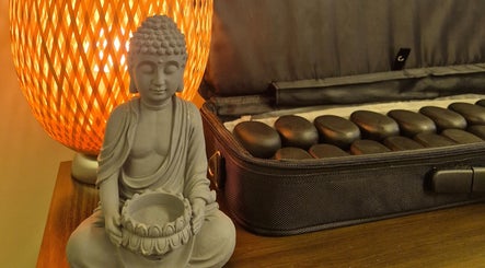 Cozy Buddha statue and stones at Mandi O'Neill Holistics, Goole, England, GB.