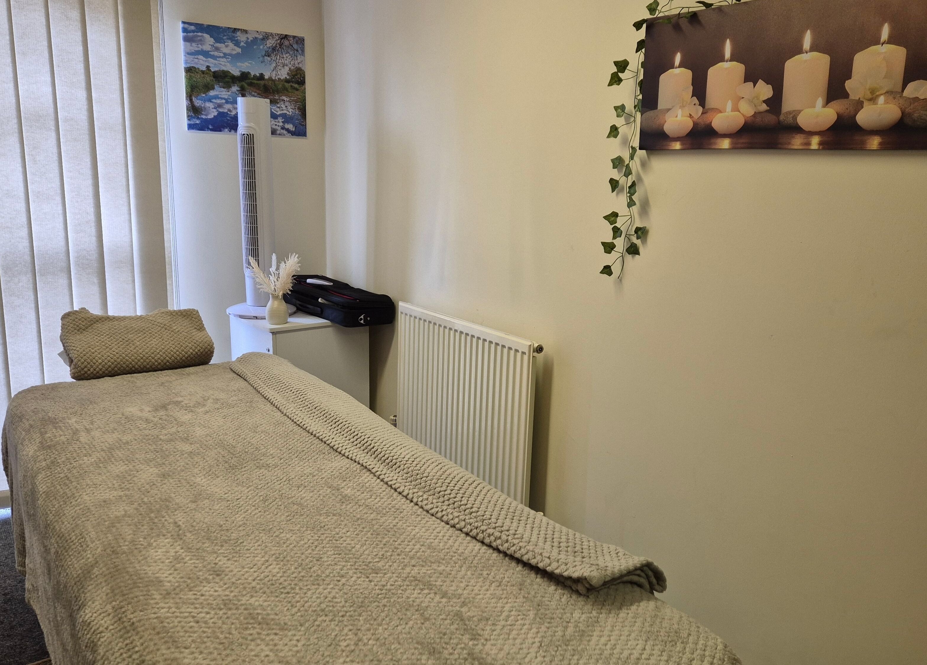 Calm treatment room at Mandi O'Neill Holistics, Goole, England, GB, with soft lighting and comfortable massage table.