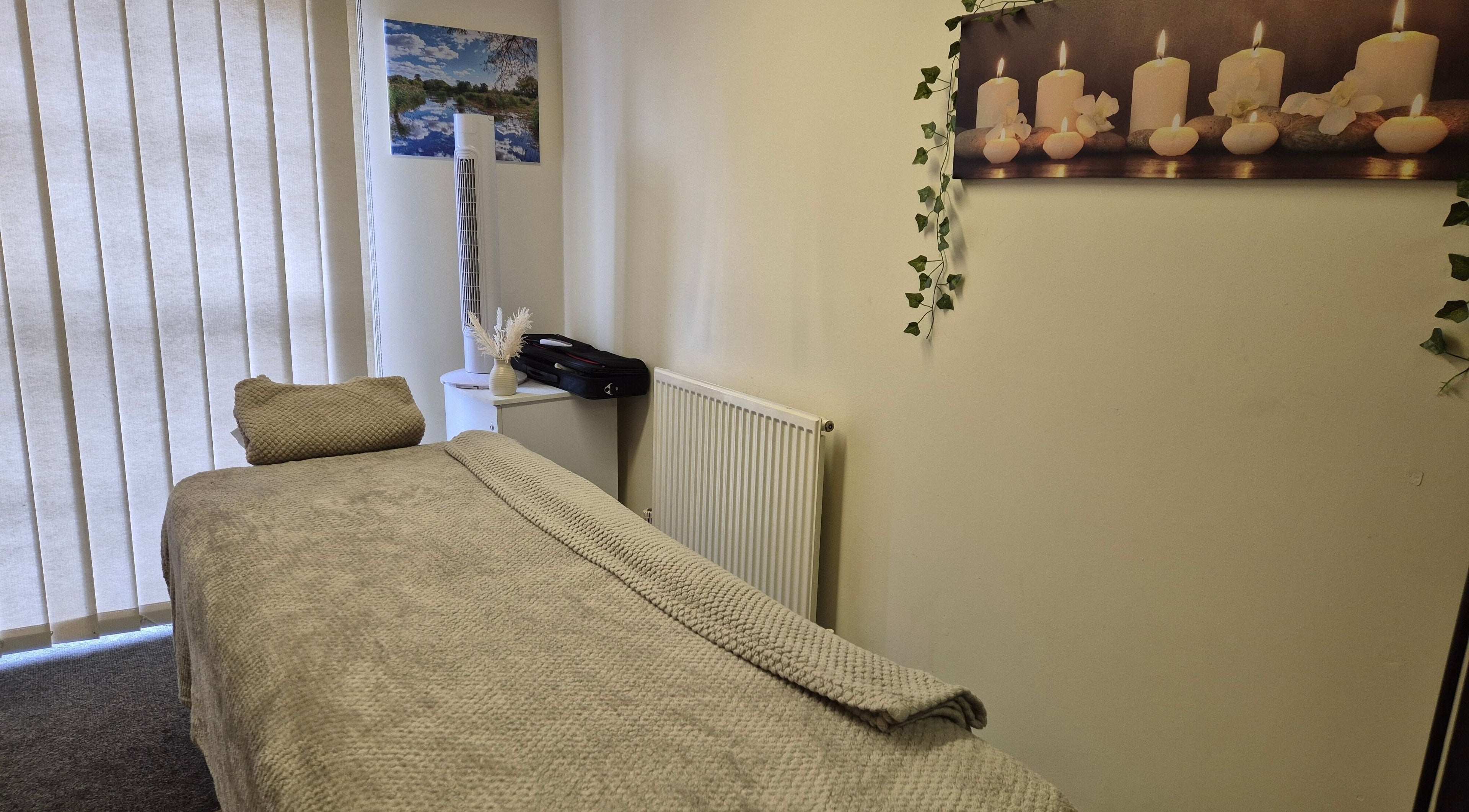 Calm treatment room at Mandi O'Neill Holistics, Goole, England, GB, with soft lighting and comfortable massage table.