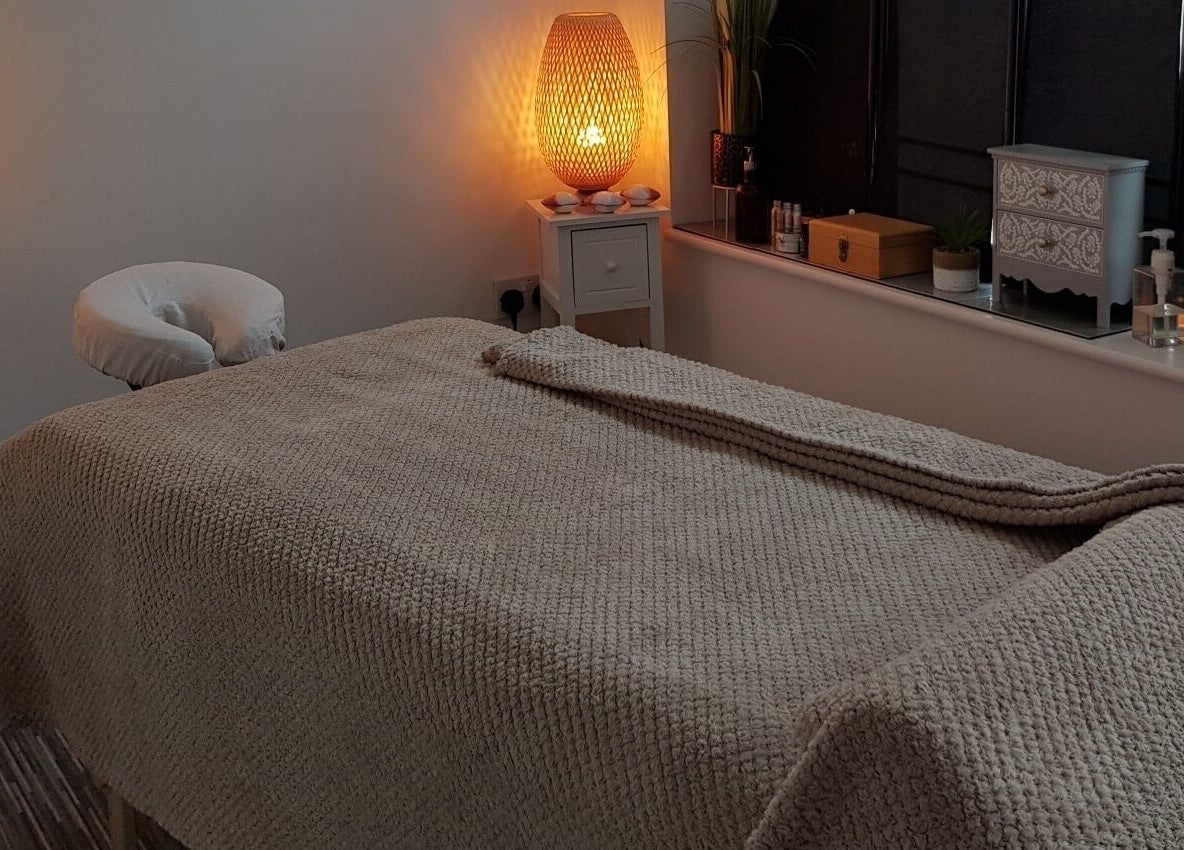 Serene treatment room at Mandi O'Neill Holistics, Goole, England, GB, with ambient lighting and cozy massage bed.