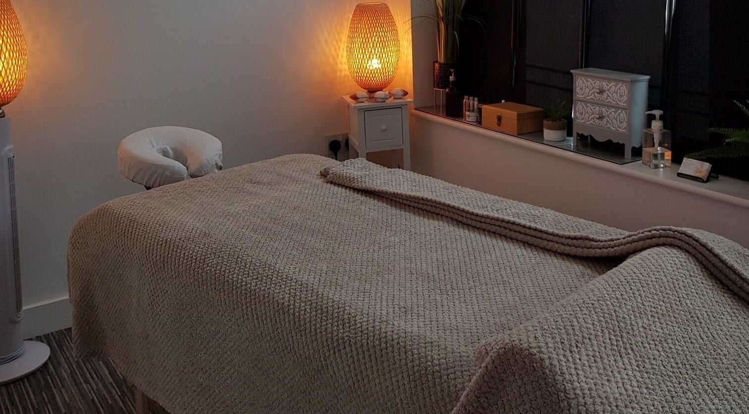 Serene treatment room at Mandi O'Neill Holistics, Goole, England, GB, with ambient lighting and cozy massage bed.