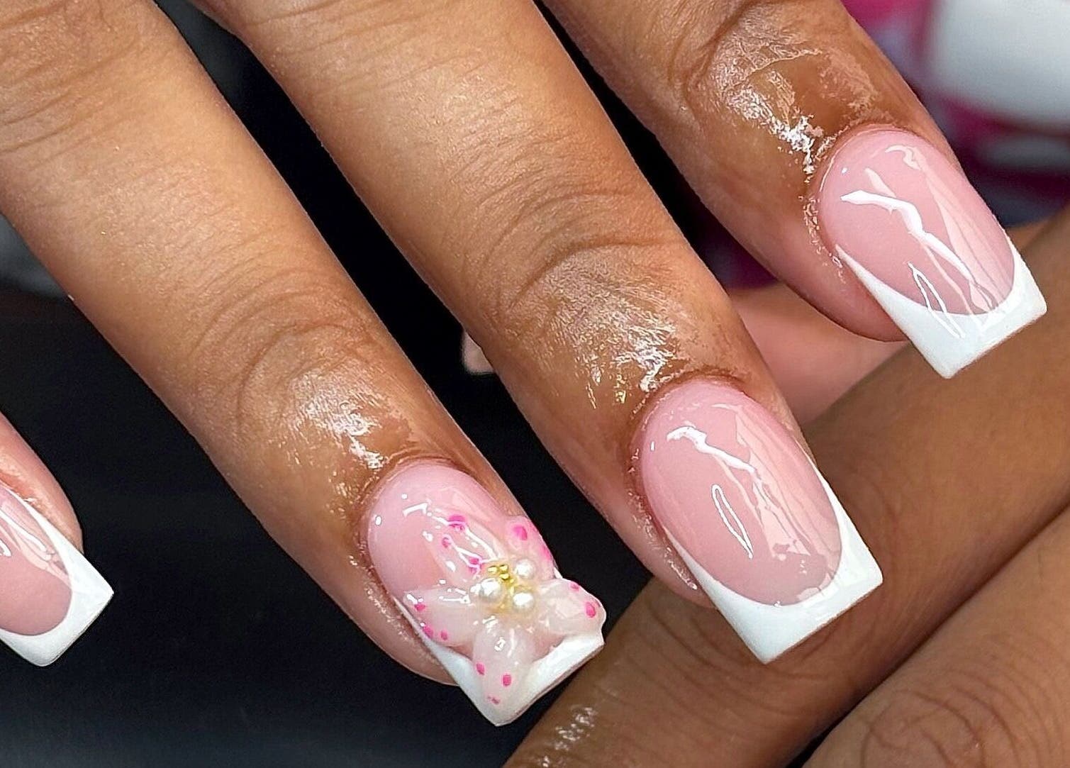 Elegant French manicure with flower detail at Nails by Kyra M, Scunthorpe, England, GB.