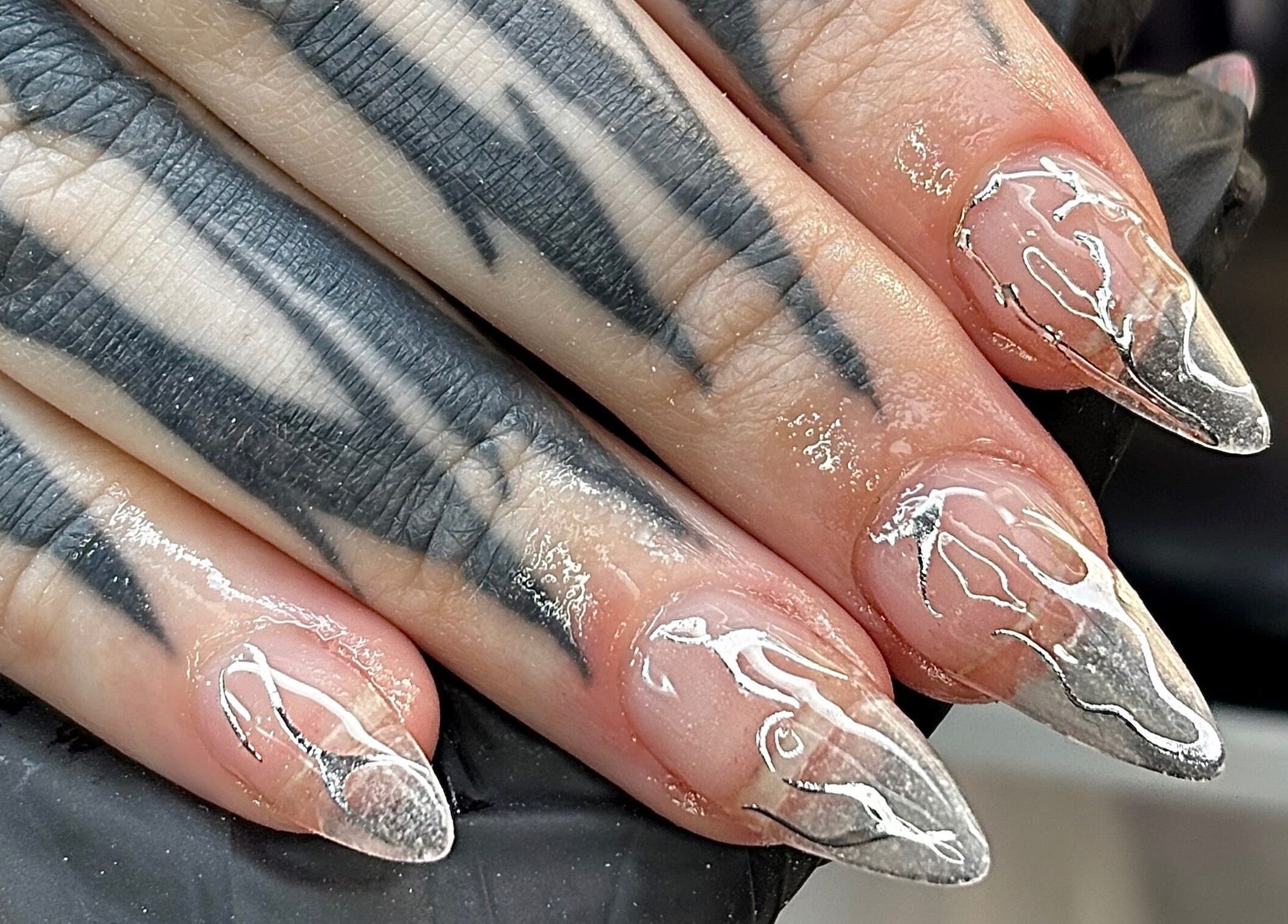 Intricate metallic nail art at Nails by Kyra M, Scunthorpe, England, GB, showcasing unique artistic detail.