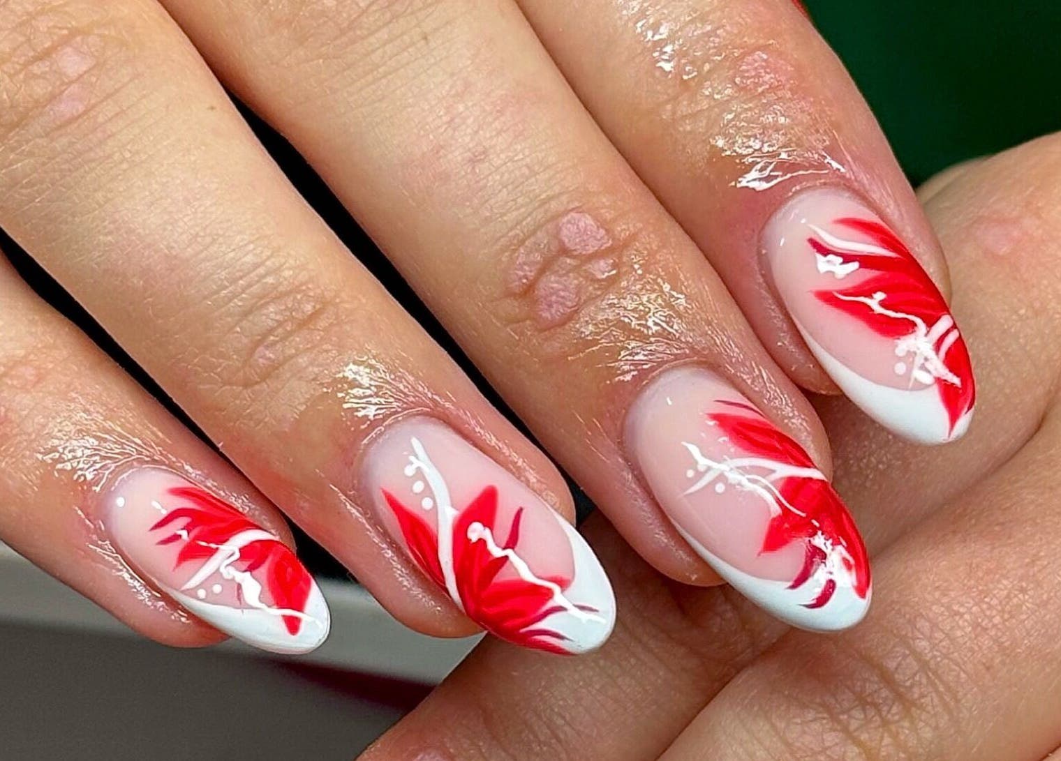 Stylish red and white floral nail art at Nails by Kyra M, Scunthorpe, England, GB.