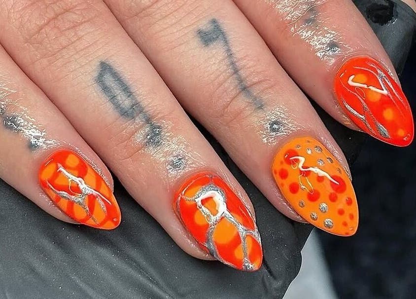Bright orange nail art with silver accents at Nails by Kyra M, Scunthorpe, England, GB.