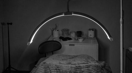 Cozy treatment room at Nue` Atelier, Port Kennedy, WA, with a massage bed and gentle lighting.