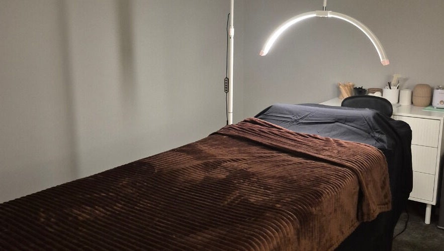 Relaxing spa room at Nuè Atelier in Port Kennedy, Western Australia with a cozy massage bed.