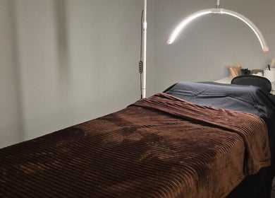 Relaxing spa room at Nuè Atelier in Port Kennedy, Western Australia with a cozy massage bed.