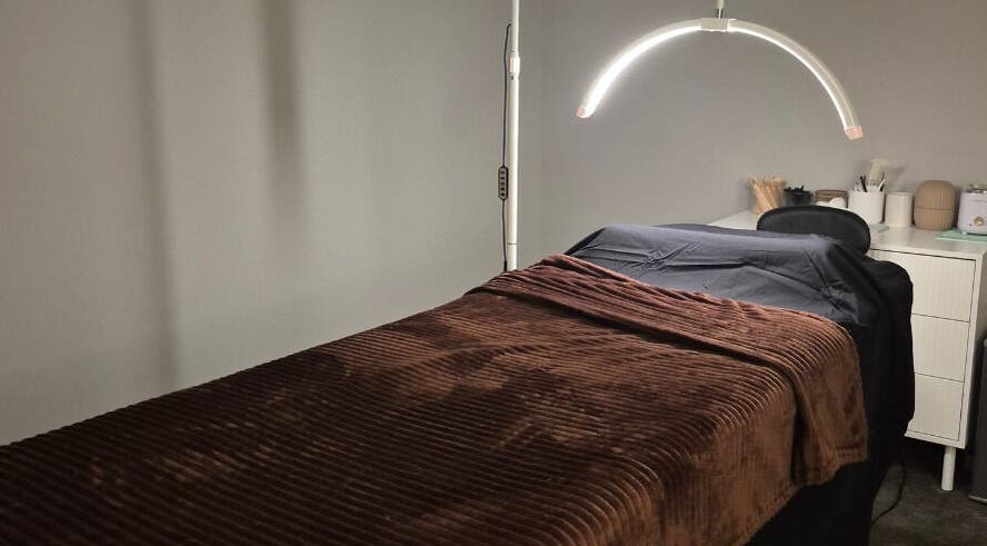 Relaxing spa room at Nuè Atelier in Port Kennedy, Western Australia with a cozy massage bed.