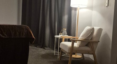 Relaxing cozy corner at Nuè Atelier, Port Kennedy, Western Australia, AU with armchair and lamp.