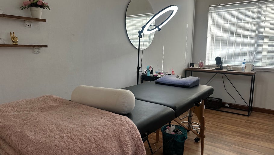 Tranquil treatment room at Glossy Aesthetics Studio in Knysna, Western Cape, ZA with a cozy bed and warm lighting.