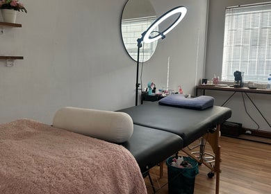 Tranquil treatment room at Glossy Aesthetics Studio in Knysna, Western Cape, ZA with a cozy bed and warm lighting.