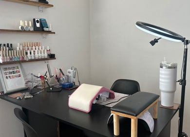 Nail station at Glossy Aesthetics Studio in Knysna, Western Cape, ZA, showcasing polish and tools.