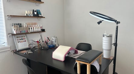 Nail station at Glossy Aesthetics Studio in Knysna, Western Cape, ZA, showcasing polish and tools.