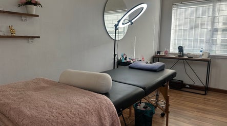 Relaxing treatment room at Glossy Aesthetics Studio, Knysna, Western Cape, ZA with a massage table and ambiance.