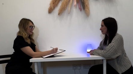 Client consultation at KLH Nurse Led Aesthetics in Morley, England, GB with warm ambient lighting.