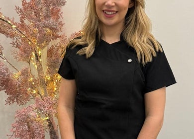 Warm welcome at KLH Nurse Led Aesthetics, Morley, England with a smiling staff beside decorative lighting.