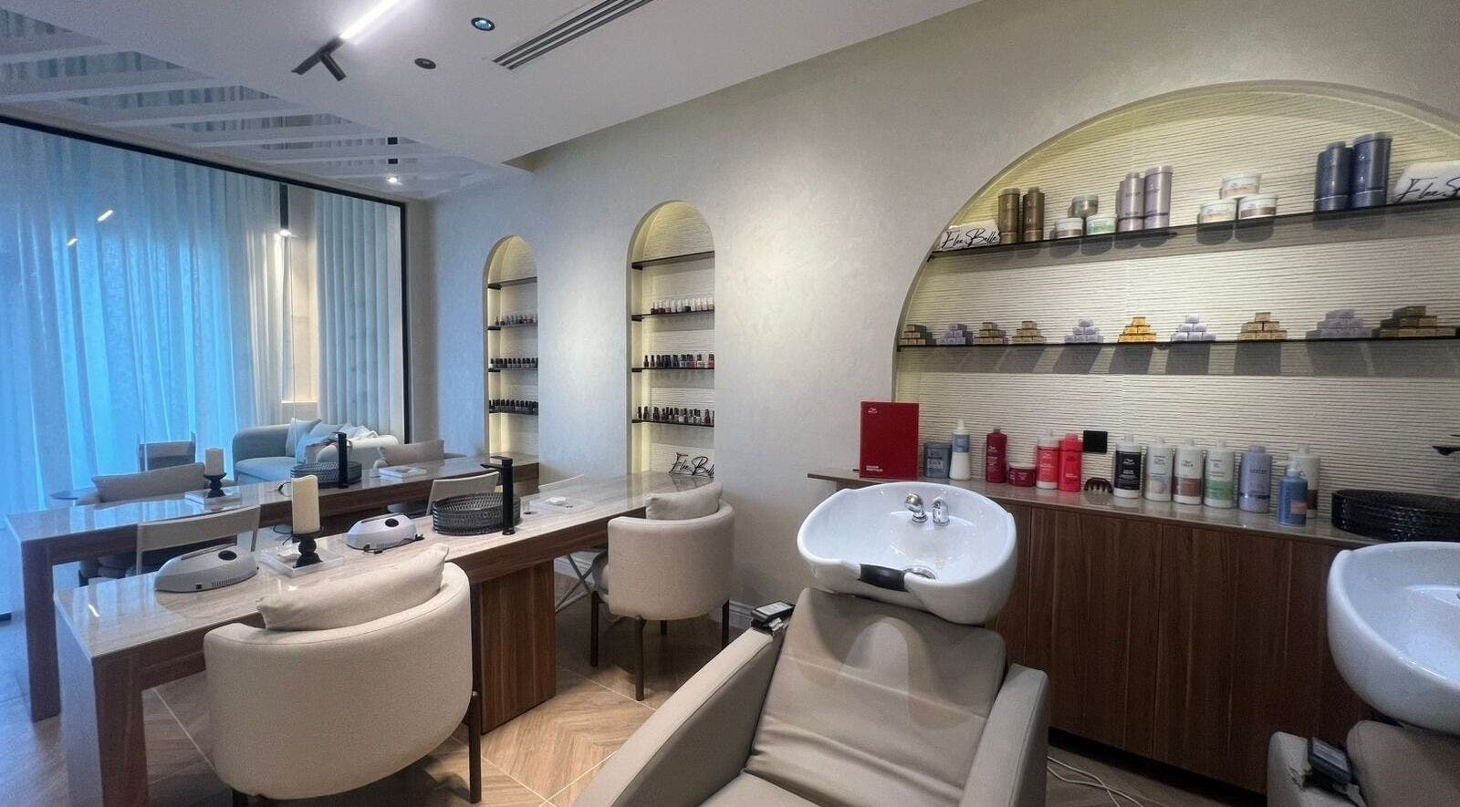 Chic and modern salon interior at Elee Belle in Al Khobar, Eastern Province, SA, featuring stylish seating and products.