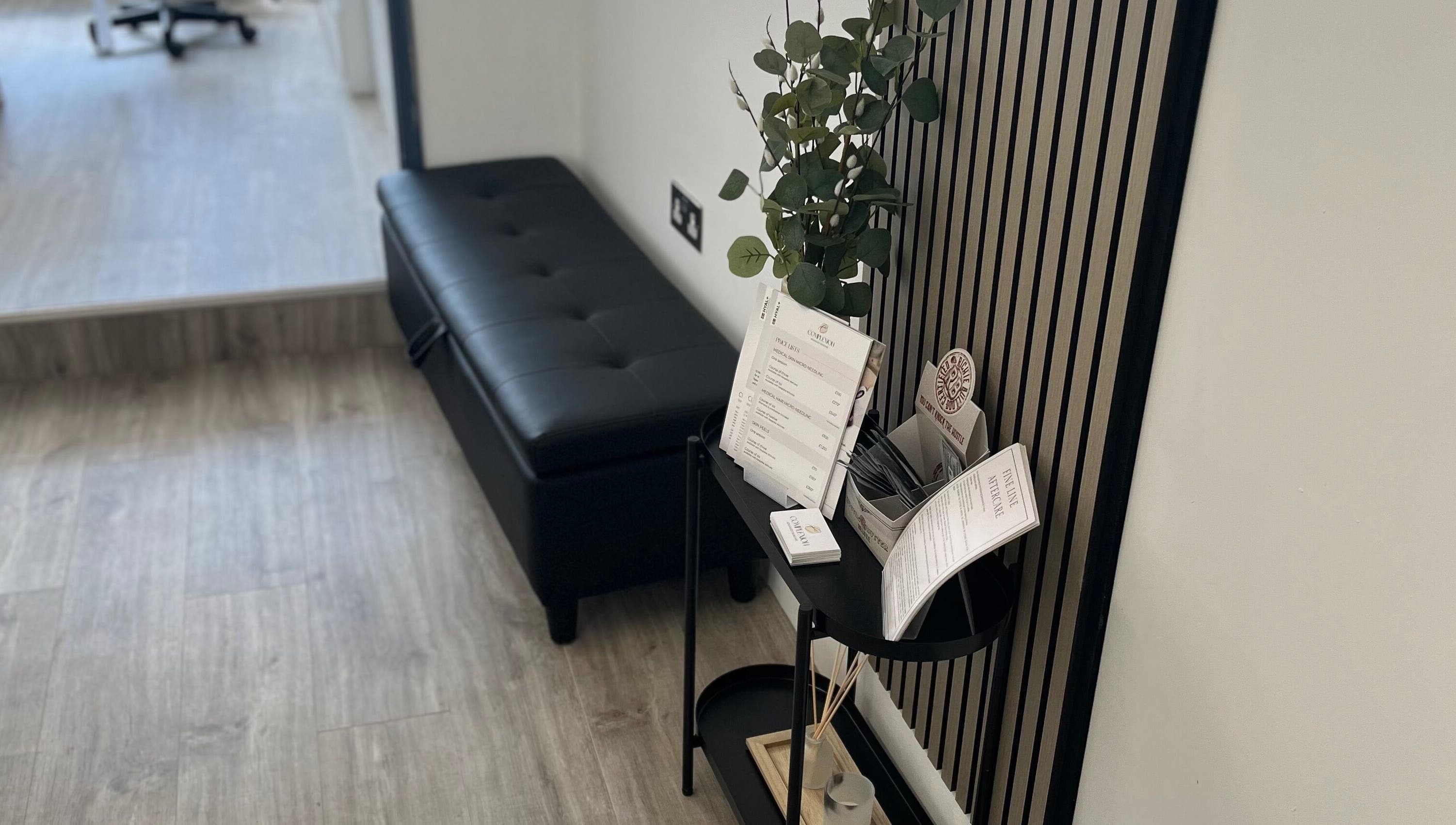 Sleek reception area in Complexion, Leighton Buzzard, GB with black bench and stylish décor.