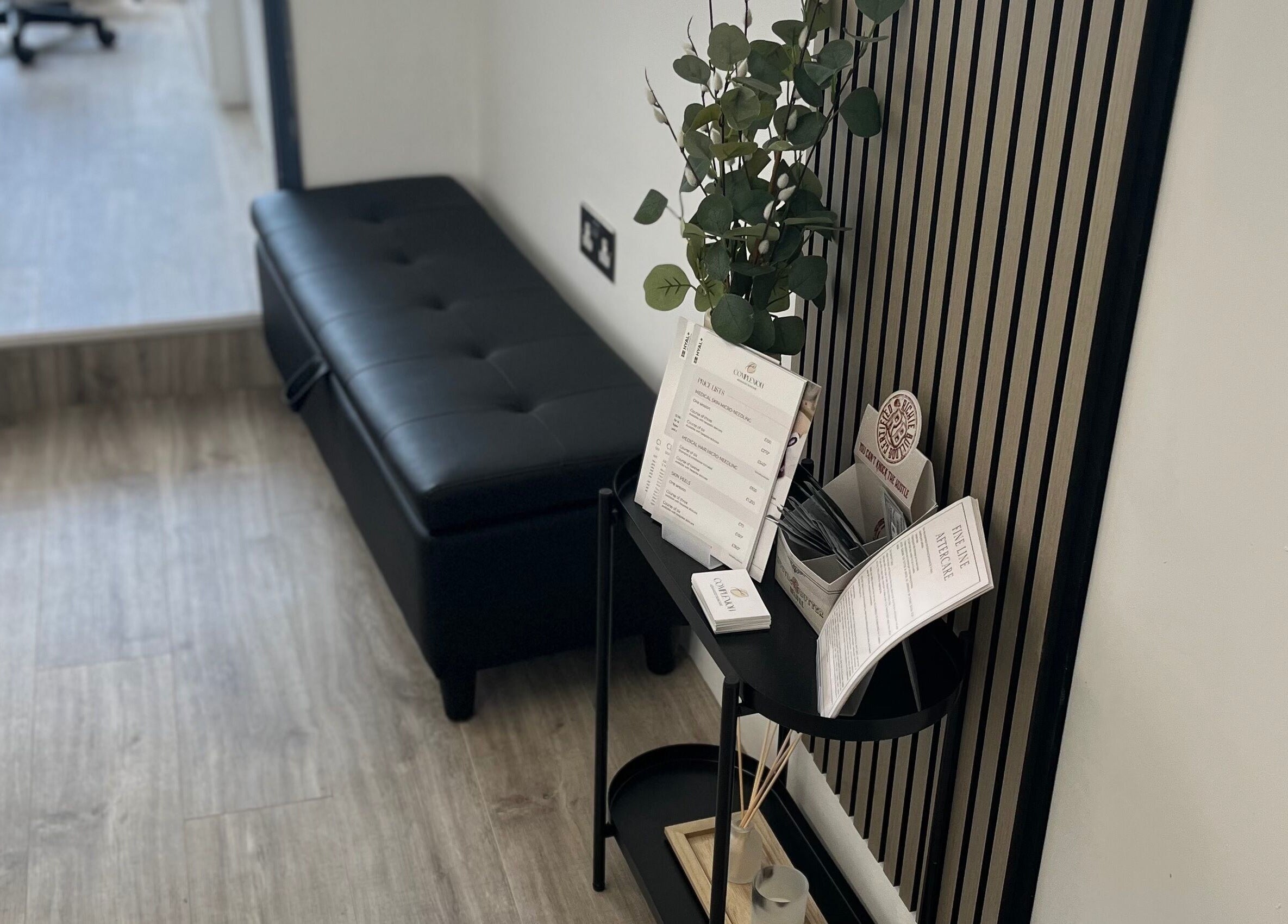 Sleek reception area in Complexion, Leighton Buzzard, GB with black bench and stylish décor.