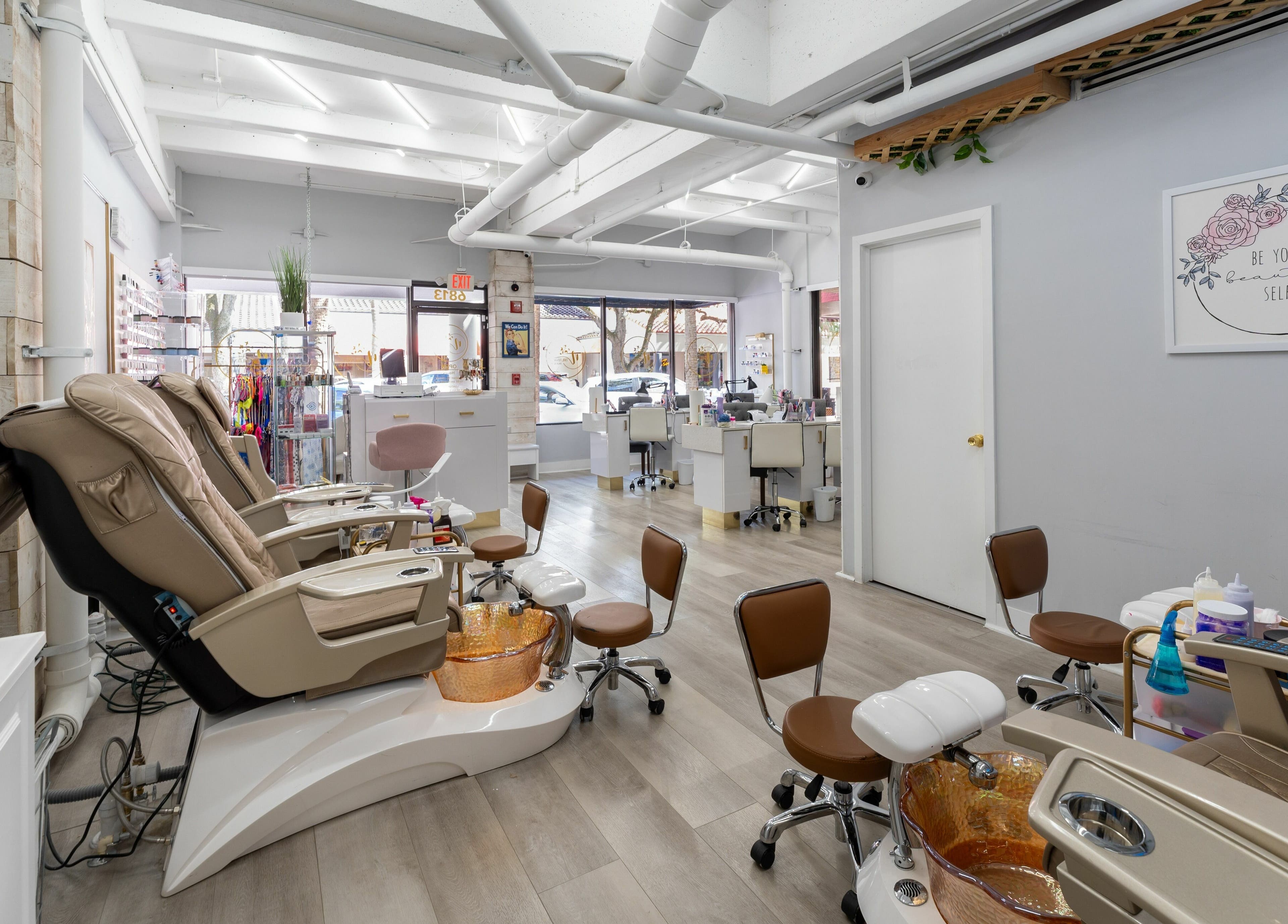 Relaxing interior of Nail Nova Salon & Spa, Miami Lakes, Florida, US. Modern pedicure chairs and stylish decor.