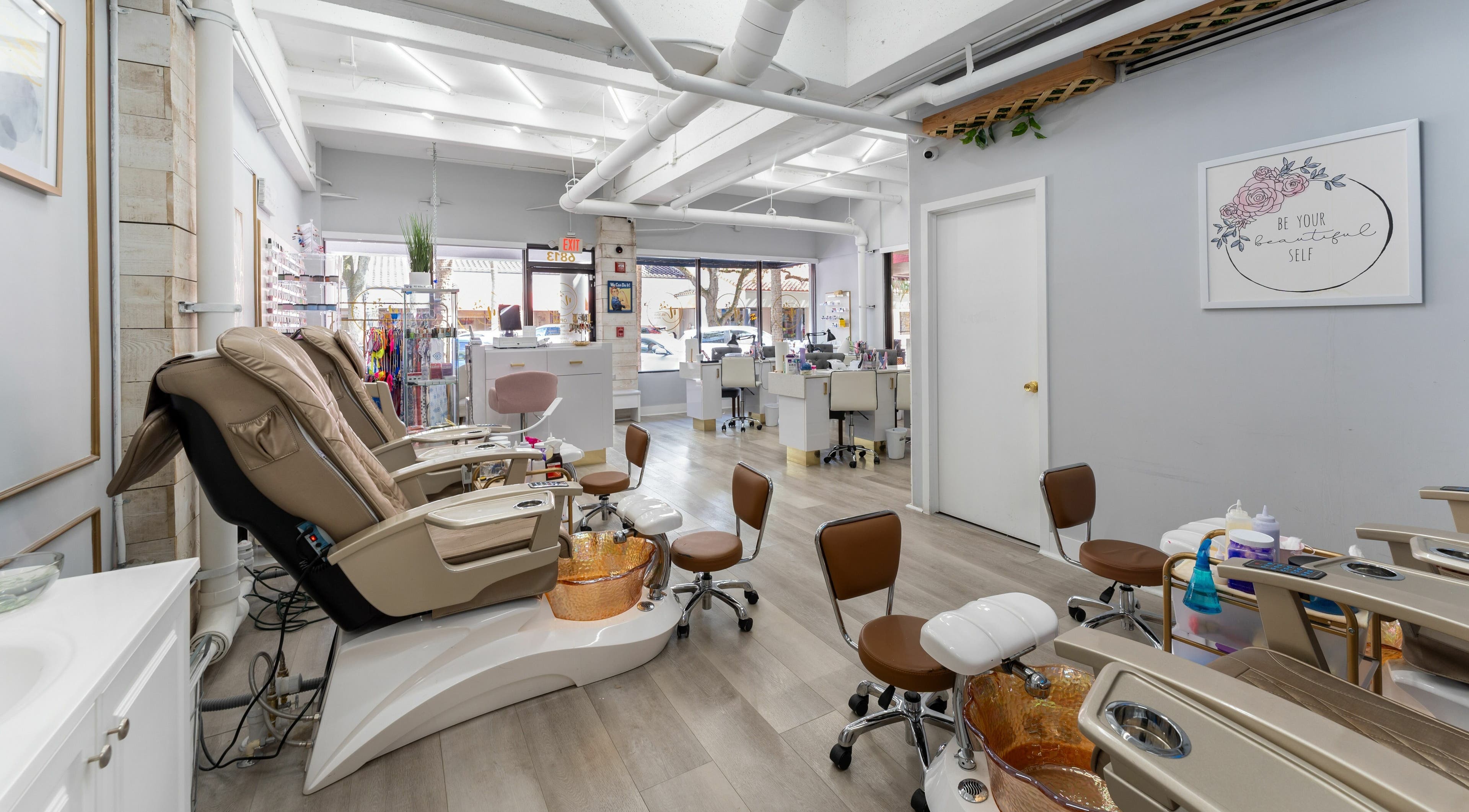 Relaxing interior of Nail Nova Salon & Spa, Miami Lakes, Florida, US. Modern pedicure chairs and stylish decor.