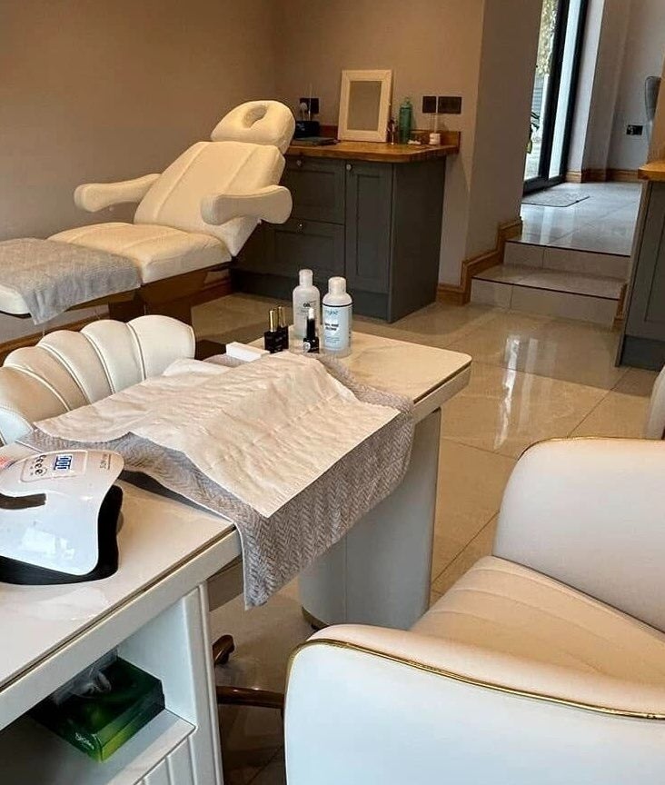 Elegant beauty treatment room at Biwti Mer, Gorsgoch, Wales, GB, featuring plush chairs and modern equipment.