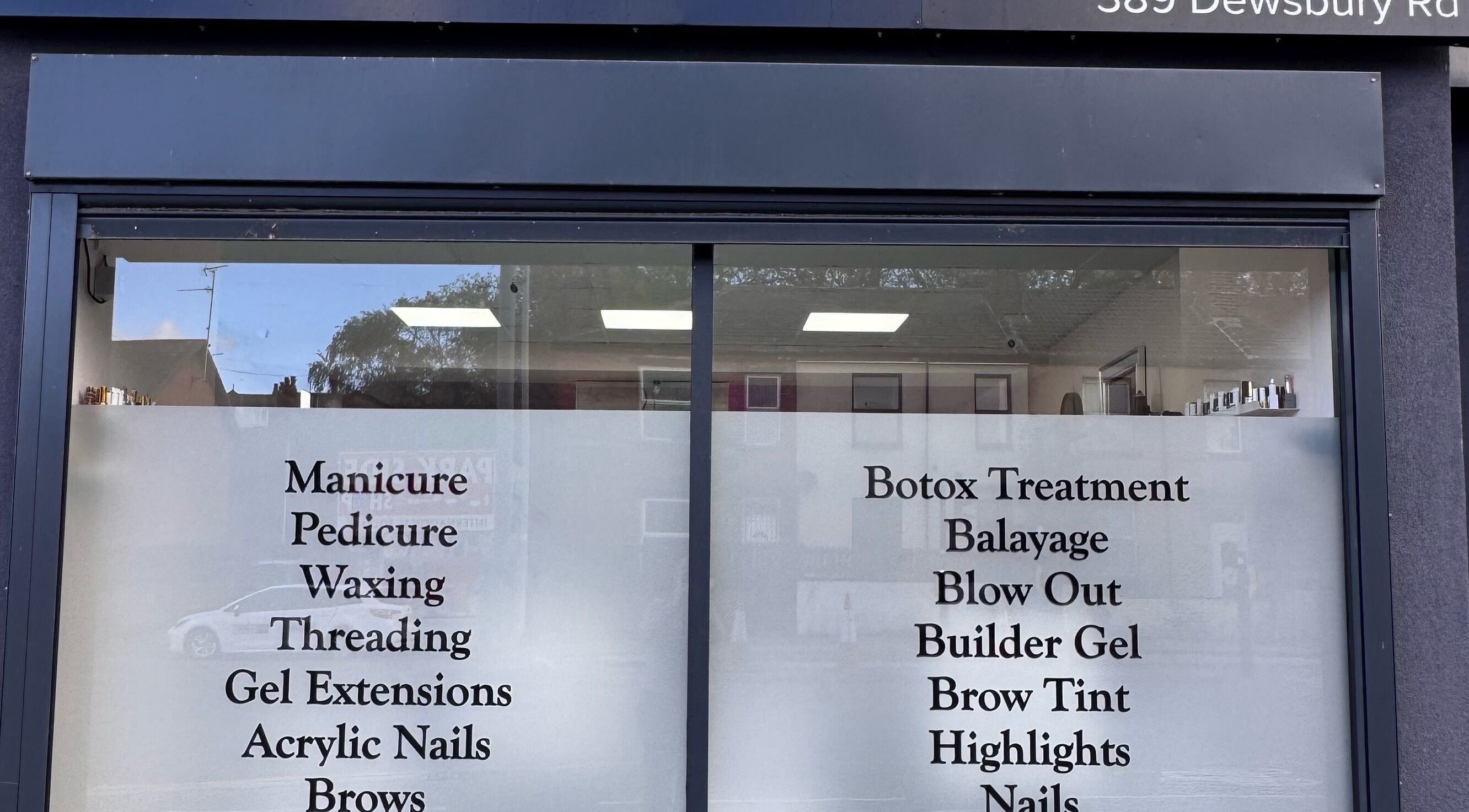Service menu on window of Glam Aura Studio, Leeds, England, GB offering manicures to botox treatments.