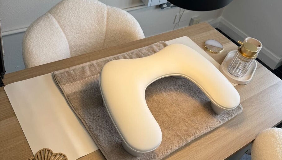 Manicure setup with ergonomic rest at Nail Envy, Nantwich, England, GB, showcasing luxury and comfort.