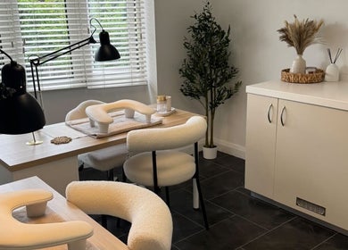 Modern nail salon setup at Nail Envy in Nantwich, England, GB with stylish chairs and decor.