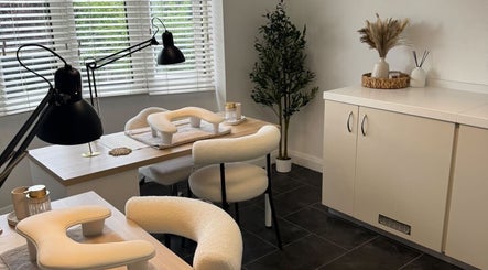 Modern nail salon setup at Nail Envy in Nantwich, England, GB with stylish chairs and decor.
