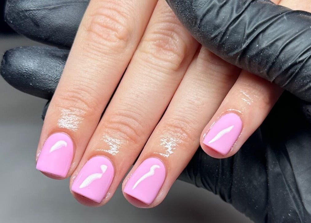 Manicure with pink polish at Olive&Co, St helier, JE offering professional nail care services.