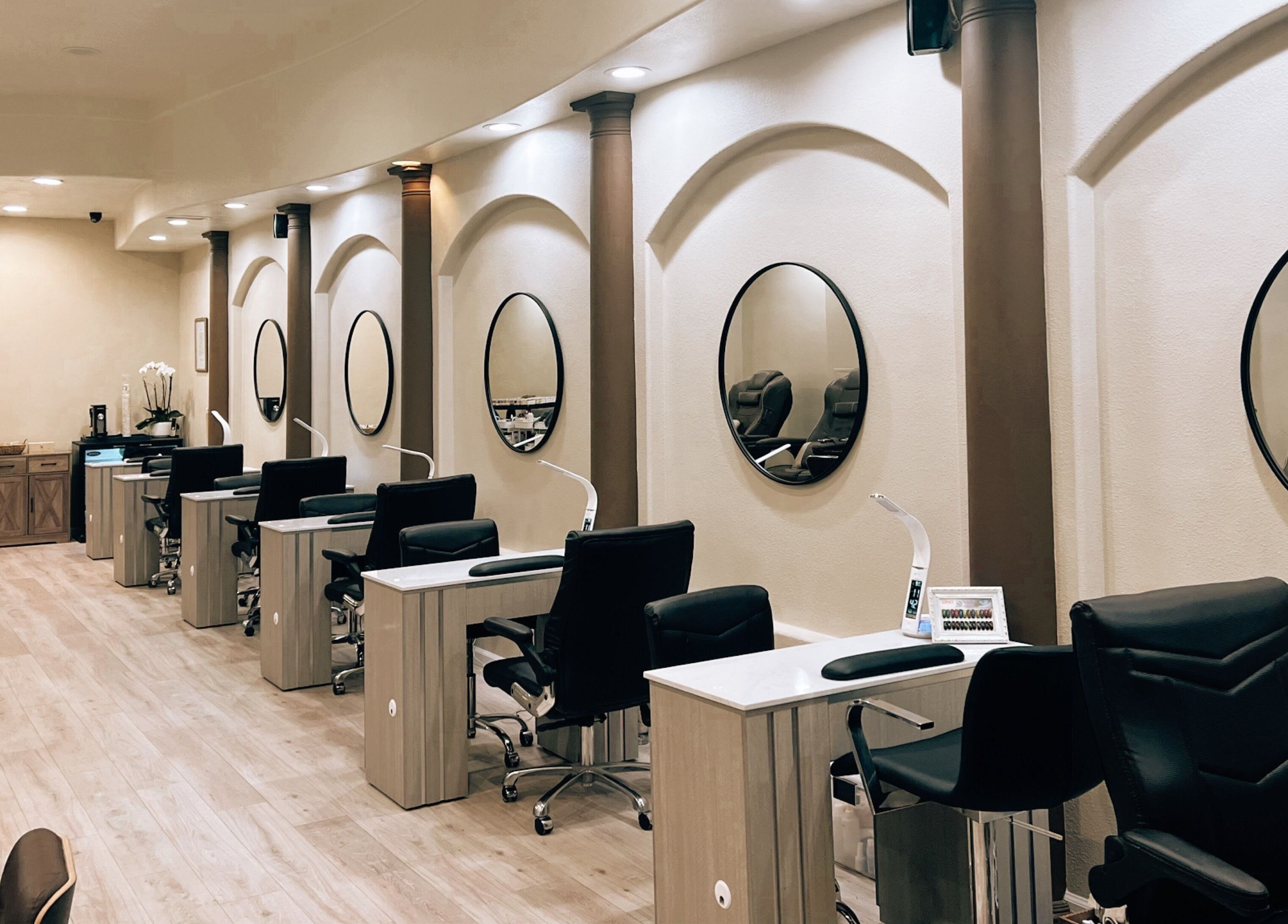 Modern nail salon interior at Nirvana Nails Studio, Studio City, California, US, featuring sleek workstations.