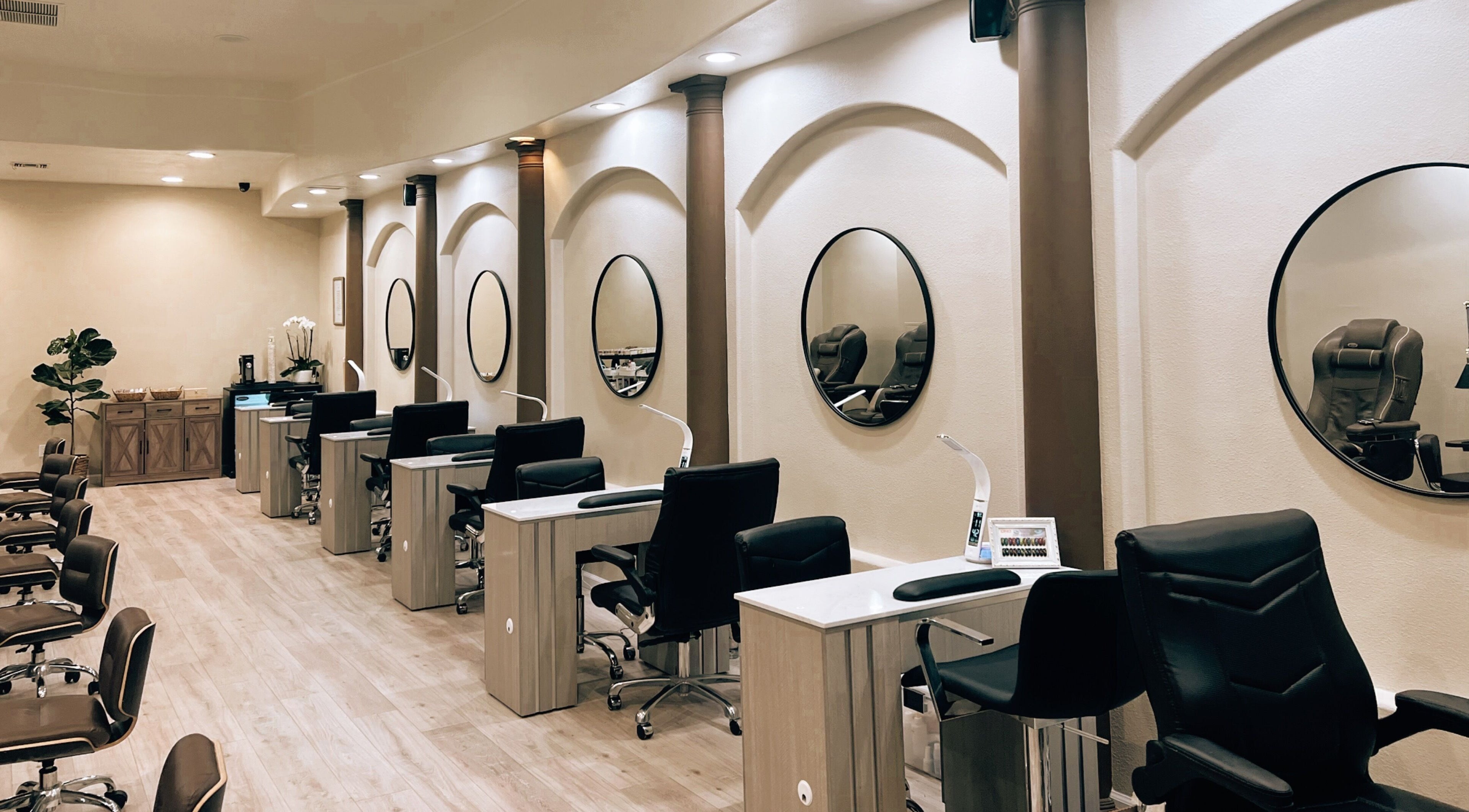 Modern nail salon interior at Nirvana Nails Studio, Studio City, California, US, featuring sleek workstations.