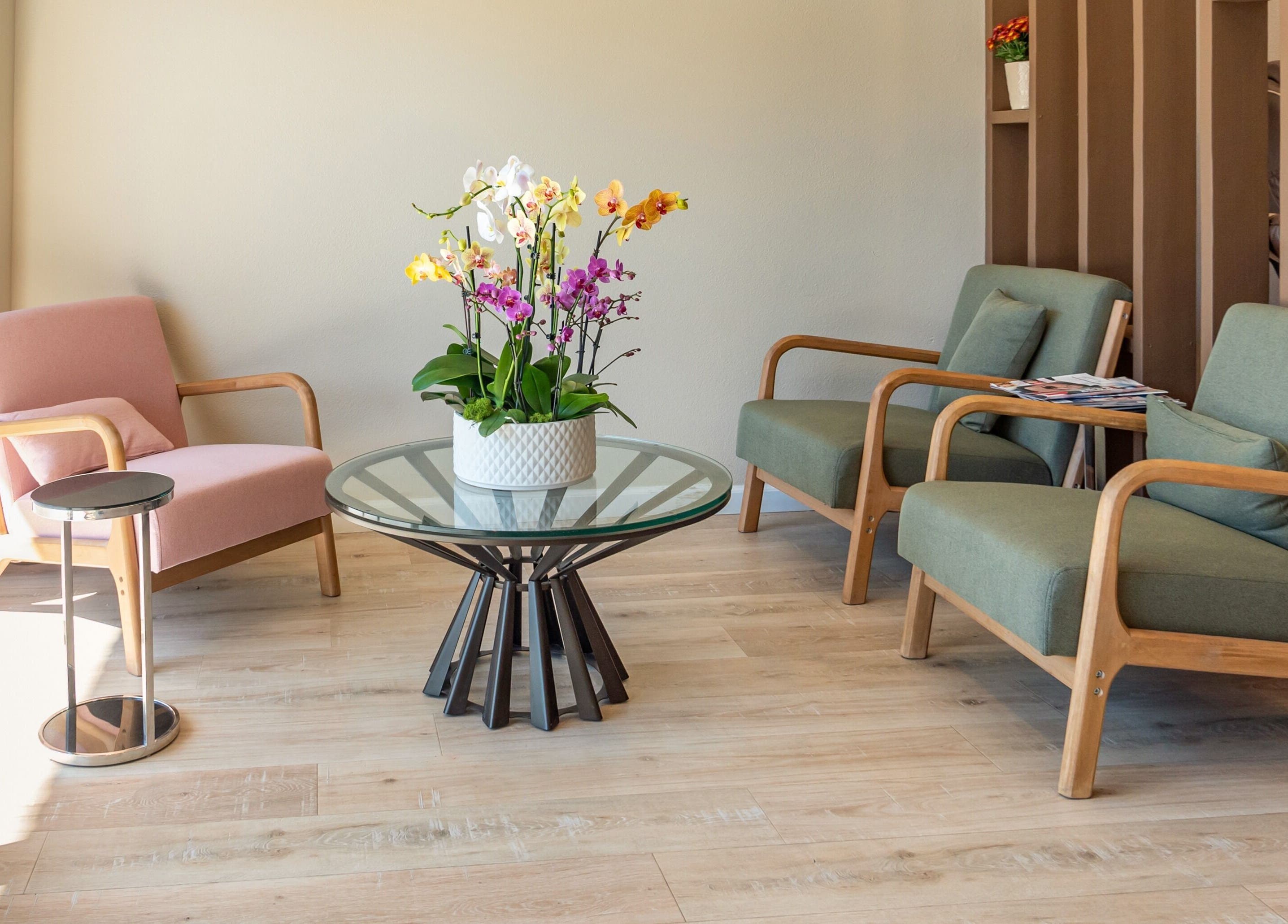 Cozy seating area with stylish chairs and orchids at Nirvana Nails Studio, Studio City, California, US.