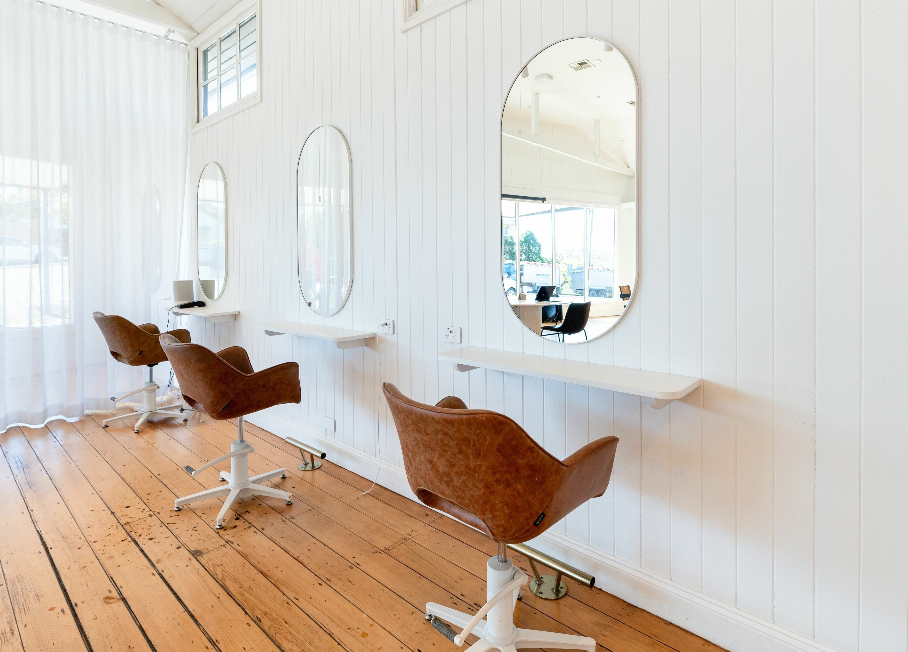 Chic salon chairs and mirrors at The Mane Society in Kelvin Grove, Queensland, AU. Modern, bright, inviting space.