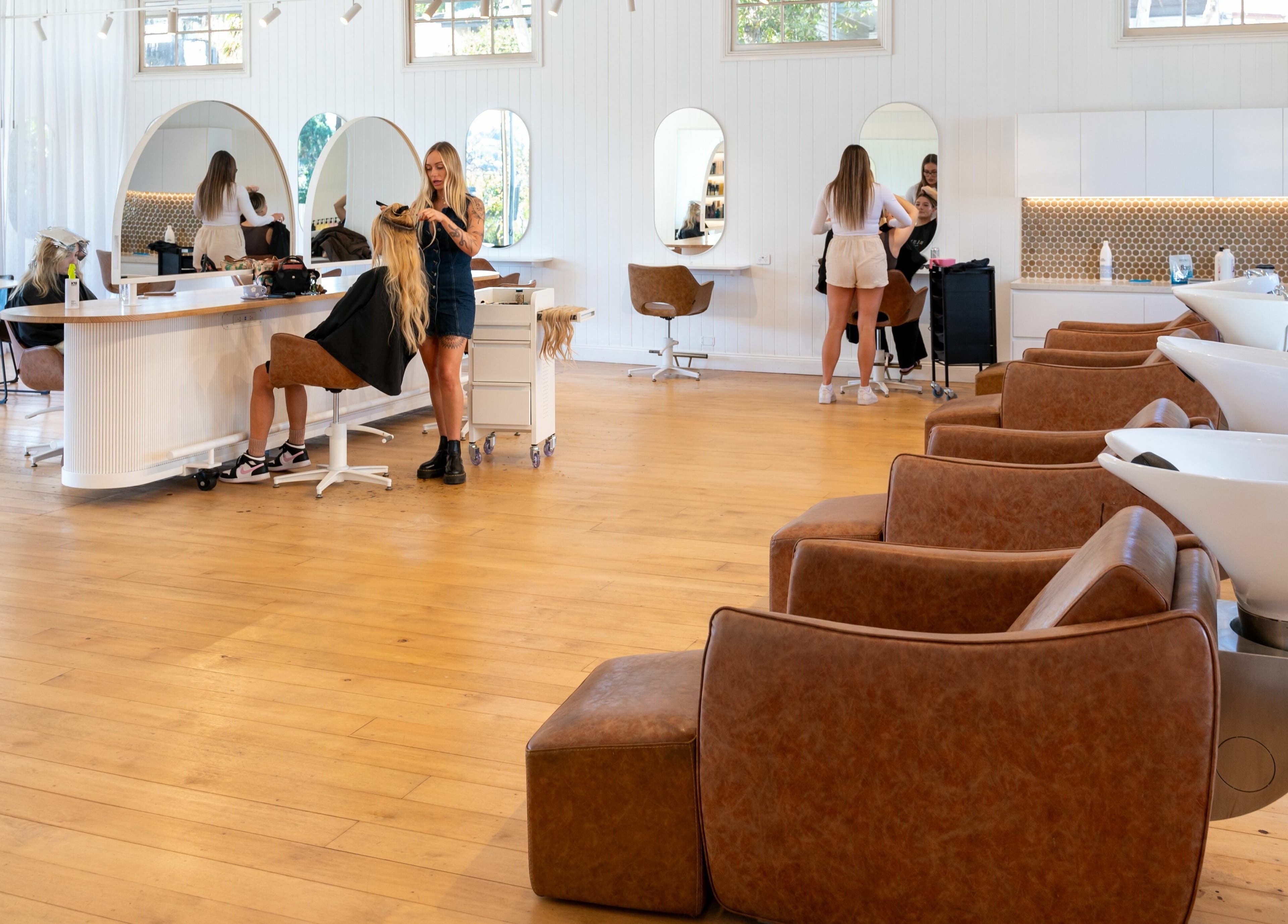 Spacious salon interior at The Mane Society, Kelvin Grove, Queensland, AU with stylists and clients in action.