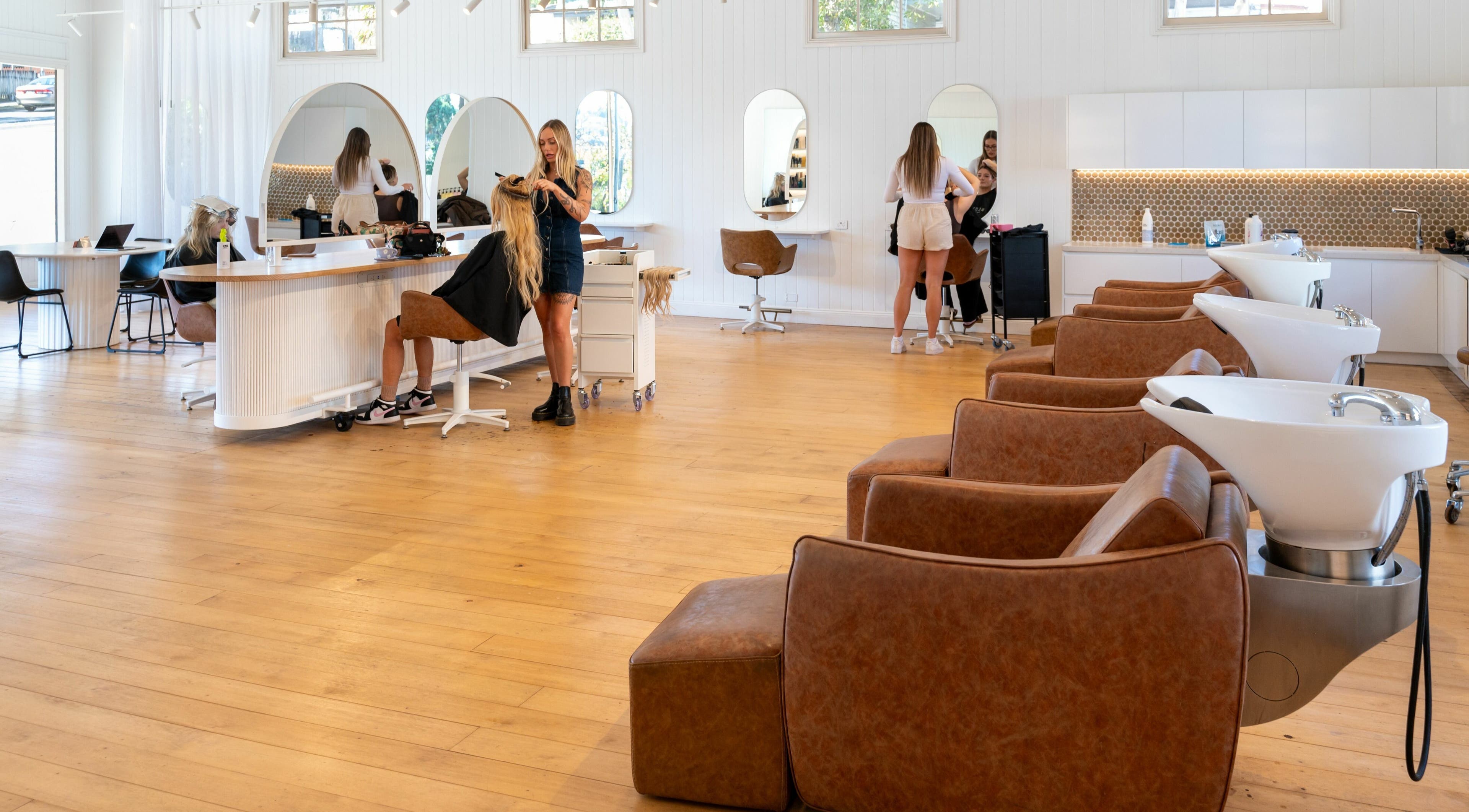 Spacious salon interior at The Mane Society, Kelvin Grove, Queensland, AU with stylists and clients in action.