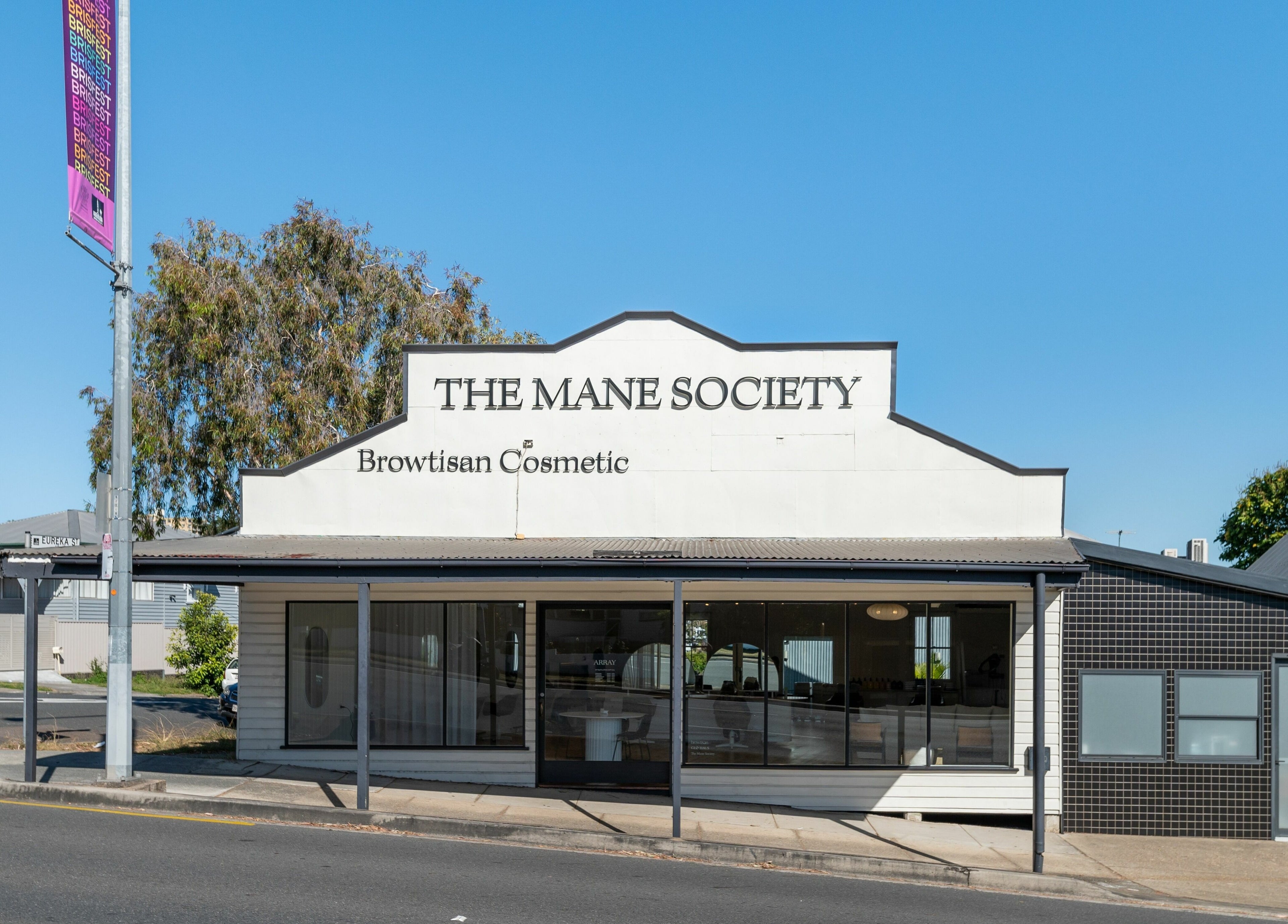 Exterior view of The Mane Society, Kelvin Grove, Queensland, AU under clear blue sky.
