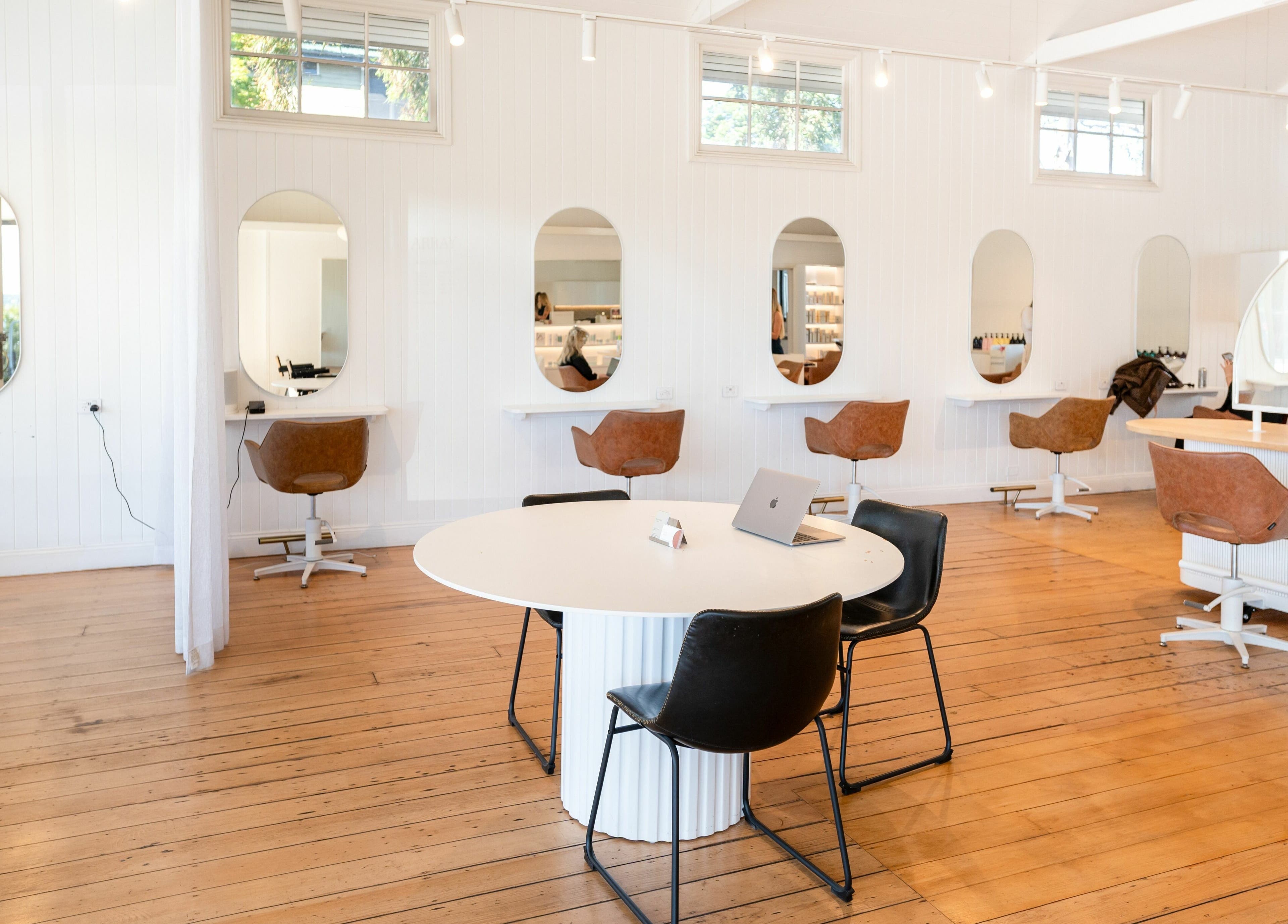 Modern interior of The Mane Society in Kelvin Grove, Queensland, AU with stylish chairs and mirrors.